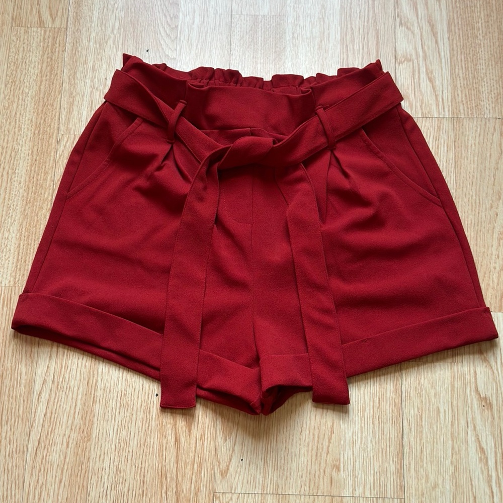 Red high-waisted shorts with belt